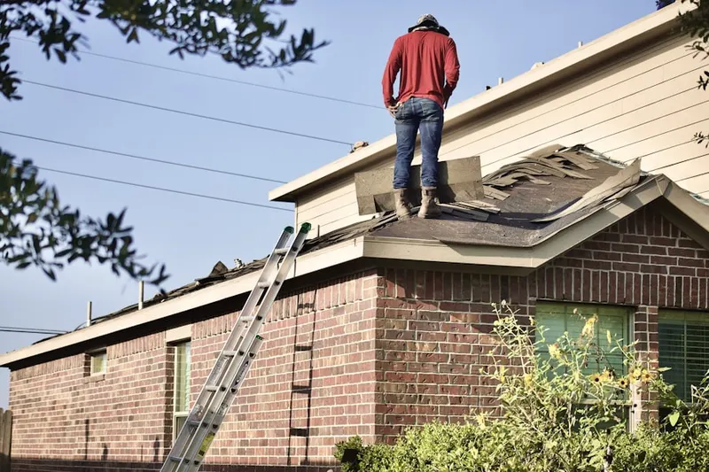 Professional roofer working on a residential roof in Independence Square